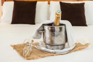 a container with a wooden spoon in it on a bed at Hostal Doris in Colonia Sant Jordi