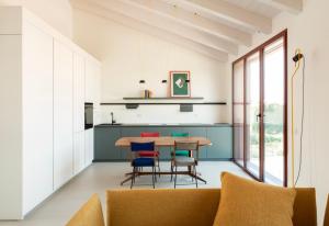 a kitchen with a wooden table and chairs at Molly Apartments in Formigine