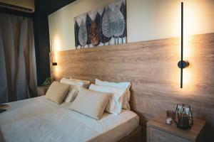 a bedroom with a bed with white sheets and pillows at Cozy Studio #10 in Malia