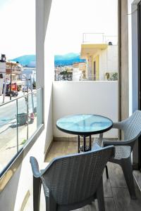 a table and chairs on a balcony with a view at Cozy Studio #10 in Malia