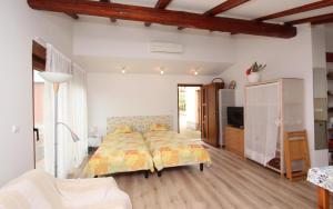 a bedroom with a bed and a living room at Studio Rovinj Home in Rovinj