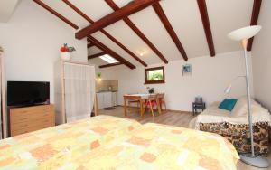 a bedroom with two beds and a dining room at Studio Rovinj Home in Rovinj