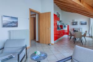 a living room with a couch and a table at Veloccino del Lago in Perledo