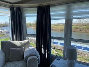 a living room with a view of a river at On the river Severn - Severnside Boat & Caravan Park, Caravan 9 in Tirley