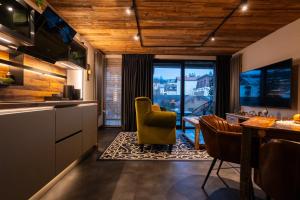 a kitchen and dining room with a table and chairs at LUNA Luxury Apartments - Adults Only - sauna, jacuzzi in Szklarska Poręba