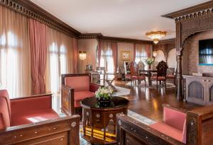 a living room with red chairs and a table at AJWA Sultanahmet - Preferred Hotels LVX Collection in Istanbul