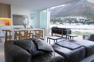 a living room with a couch and a table at Beachfront @ Beach Club in Cape Town