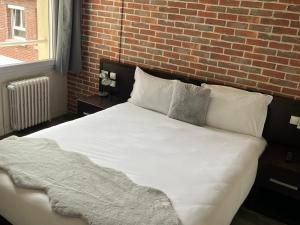 Postel nebo postele na pokoji v ubytování Hotel Au Spatial