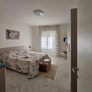 a bedroom with a large bed and a window at La piccola gemma in Saviano