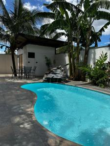 a swimming pool in front of a house at Narime Costa Rica in Palmira