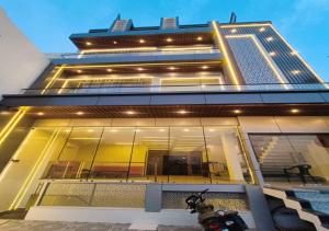 a building with a motorcycle parked in front of it at Hotel R.Raghavam in Ayodhya