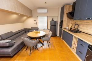 a kitchen and a living room with a couch and a table at Djanina 3 in Sandanski