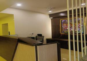 a room with a desk and a tv on the wall at Hotel R.Raghavam in Ayodhya