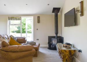a living room with a couch and a fireplace at Blenkett Wood Lodge Park in Grange +37 photos