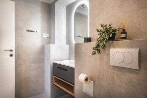 a bathroom with a sink and a mirror at D&A Central Luxury Apartments with FREE Parking in Pula