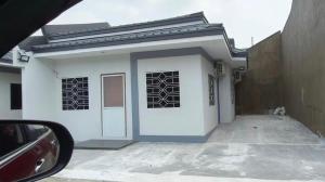 a white house with a dog sitting in front of it at Rapha's Place Joy - A in Bacolod