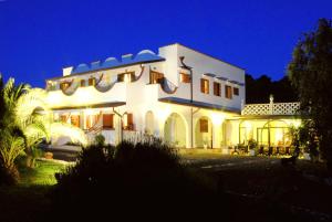 a large white house at night with lights at Poggio di Luna Adults Only in Peschici