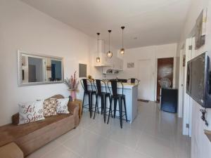 a living room with a couch and a kitchen at Rapha's Place Joy - A in Bacolod
