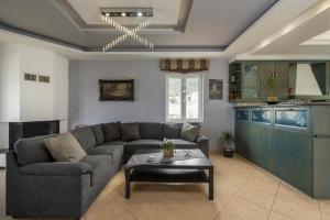 una sala de estar con un sofá y una mesa en Maison Evelyn, en Tsikalariá