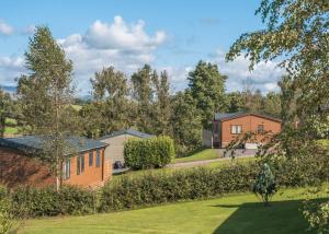 a view of a garden with houses in the background at Docker Holiday Park in Carnforth