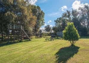 a park with a playground and a picnic table at Docker Holiday Park in Carnforth