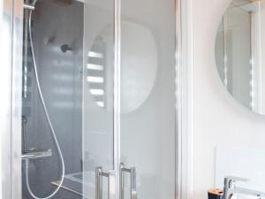 a shower with a glass door in a bathroom at Charmante tiny house avec baie extérieure et kota grill à Manoncourt-en-Vermois - FR-1-584-374 in Manoncourt-en-Vermois +16 photos