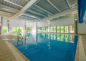 a large swimming pool with a large blue swimming pool at Fell End in Milnthorpe