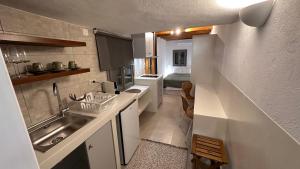 a small kitchen with a sink and a counter top at Amerissas studios 1 in Skiros