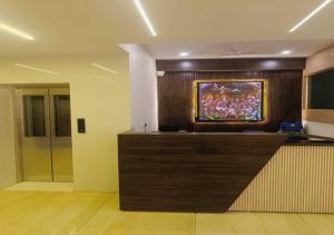 a lobby with a bar with a football painting on the wall at Hotel R.Raghavam in Ayodhya
