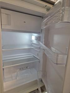 a white refrigerator with its door open and its drawers at Auszeit am Weinhof in Loschenthal