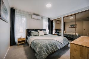 a bedroom with a bed and a large window at Retreat, Relax, Repeat in Katoomba, Blue Mountains in Katoomba +49 photos
