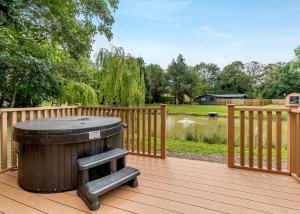 a trash can sitting on a deck with a fence at Killerby Old Hall in Scarborough
