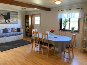 a dining room with a table and chairs and a couch at Mellbystrand in Mellbystrand