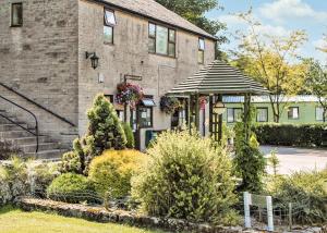 a house with a gazebo in front of it at Lime Tree Park in Buxton
