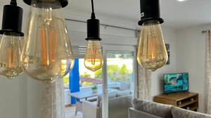 a group of lights hanging in a living room at Retama Somhome Peñiscola in Peñíscola