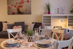a dining room table with plates and glasses on it at Casa Lauda in Bad Vöslau in Bad Vöslau