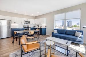 un soggiorno con un divano blu e una cucina di Motif Nashville's Hotel on Music Row a Nashville