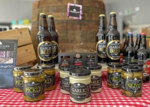 a table with bottles of beer and jars of pickles at Orchards Holiday Park in Newbridge