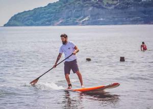 a man on a paddle board in the water at Orchards Holiday Park in Newbridge +57 photos