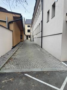 an empty alleyway between two buildings at The Hook Apartments in Dolný Kubín