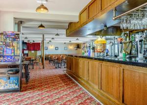 a bar in a restaurant with tables and chairs at North Shore Holiday Park in Winthorpe