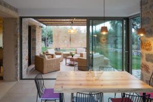 a dining room with a wooden table and chairs at Mythies - Holiday Houses in Mani in Levktron