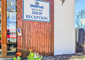 a sign on a wooden door of a store at Nethercraig Holiday Park in Alyth +44 photos
