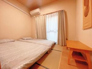 Postel nebo postele na pokoji v ubytování home story in Tokyo Okubo 東京屋語 in 新大久保 新宿