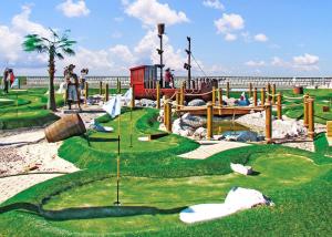 a miniature golf course with a playground on the beach at Robin Hood Rhyl in Rhyl +15 photos