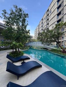 a swimming pool in the middle of a building at Dcondo Reef Serenity Condo 2 in Phuket