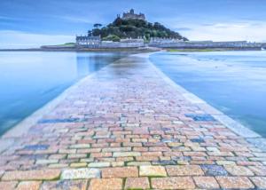 a brick pathway leading into the water with an island in the background at Stream Valley Holiday Park in Penzance