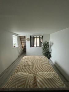 a large bed in the middle of a room at Ty'ca house in Velleron