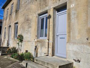 a white door on the side of a building at Gîte historique et moderne, capacité flexible - FR-1-585-170 in Mouzay