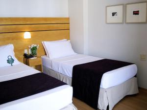 Cama ou camas em um quarto em San Diego Suítes Lourdes - OFICIAL